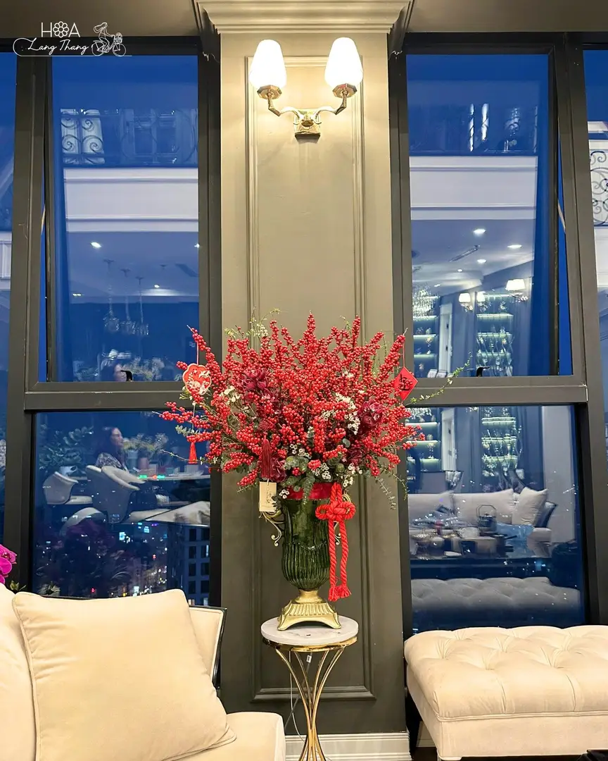 Bình hoa tươi rất đẹp với nhiều hoa đỏ và lá xanh, trang trí nội thất sang trọng